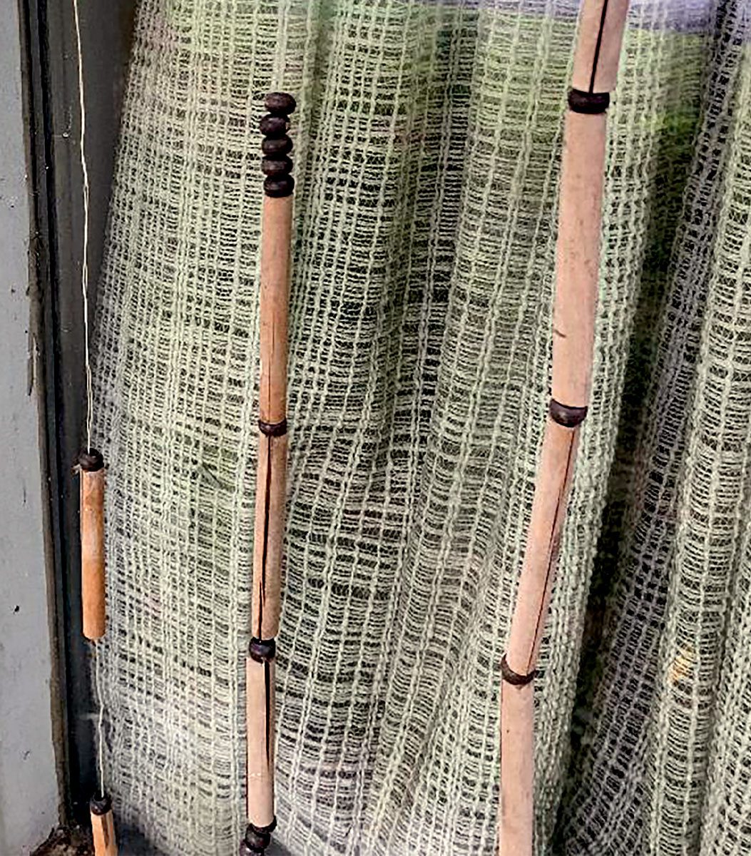 Close up of a window with strings of beads hanging.