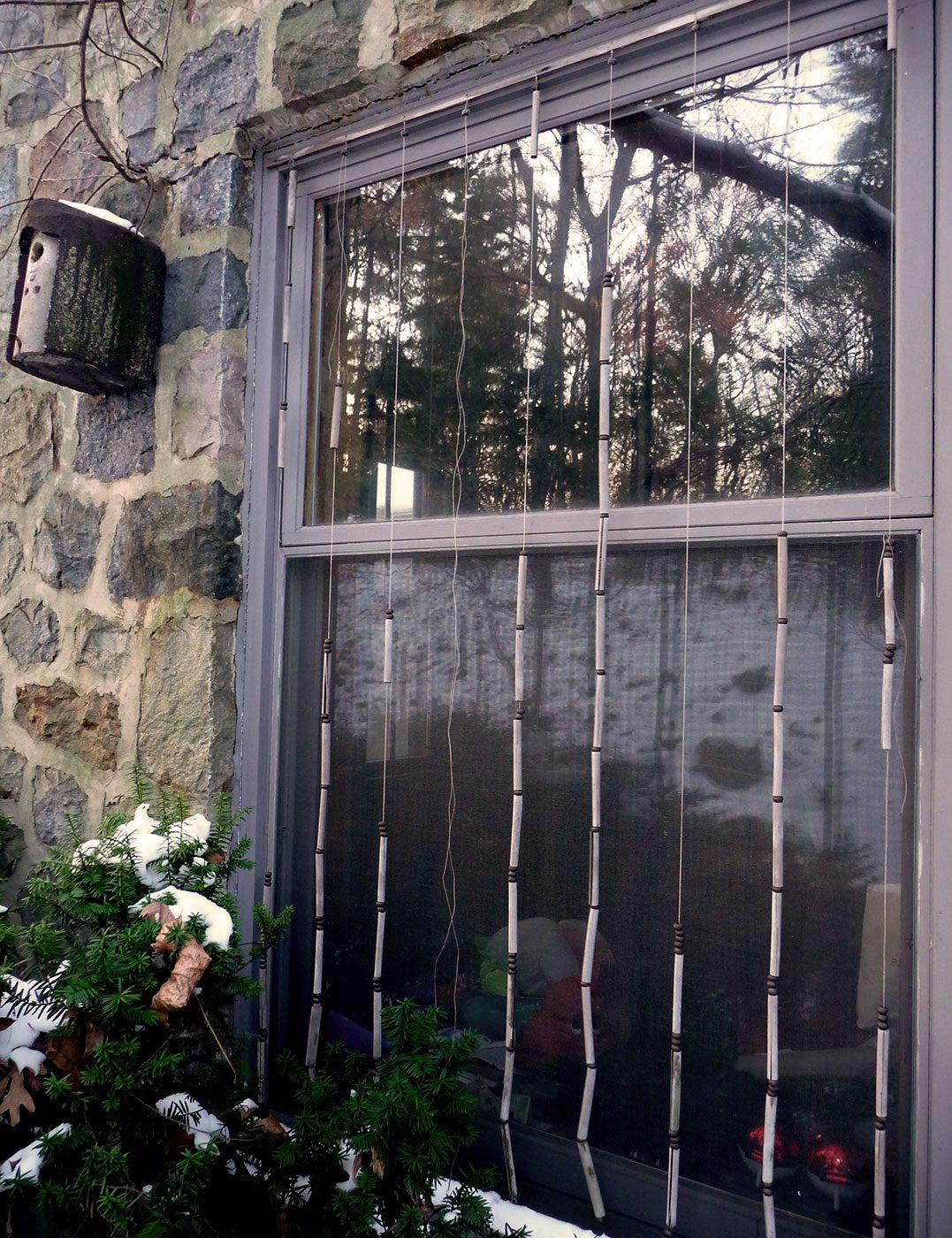 Window with beaded strings hanging along glass